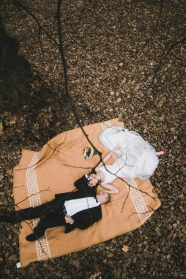 Couple lying down at the autumn park