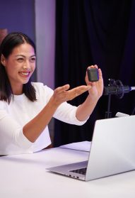 Excited techno blogger filming review of new earbuds model